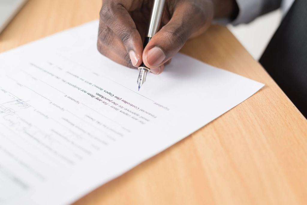 a man signing a prenup