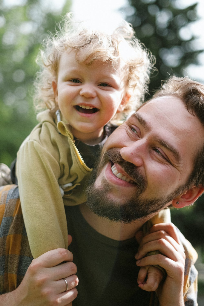 a father holding his child on his back