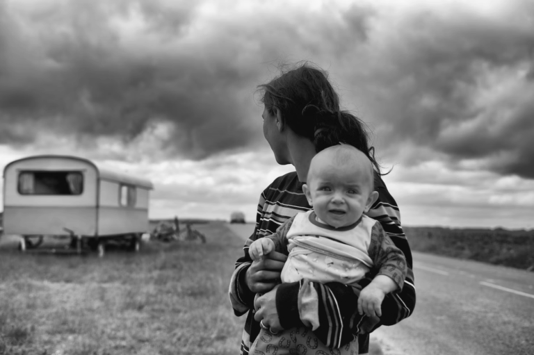 a woman holding her visibly upset baby