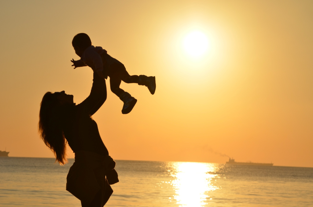 A woman with her child at the beach