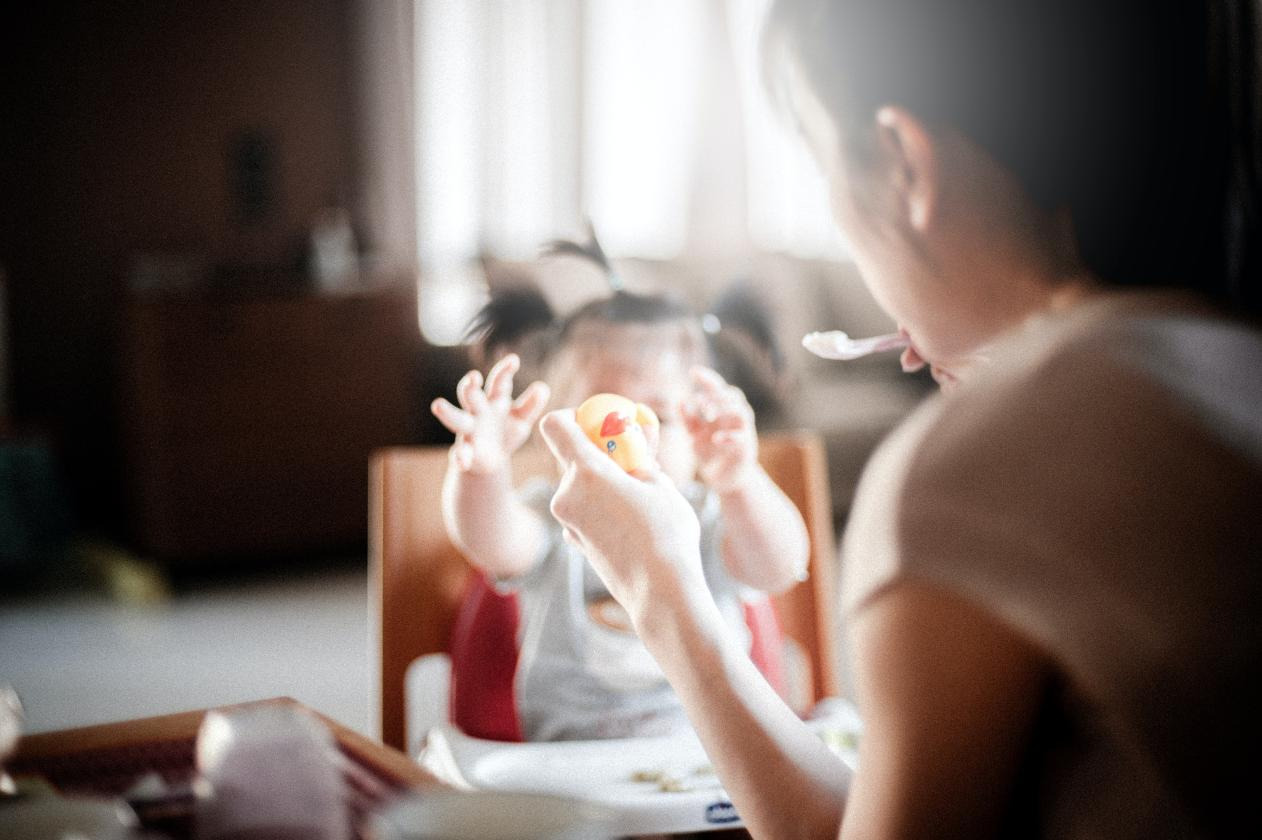 A mother trying to feed her child