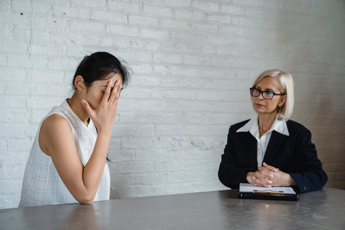 Exhausted woman in consultation with family law attorney.
