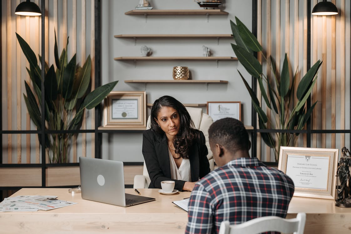 Female lawyer and male client discussing in an office.