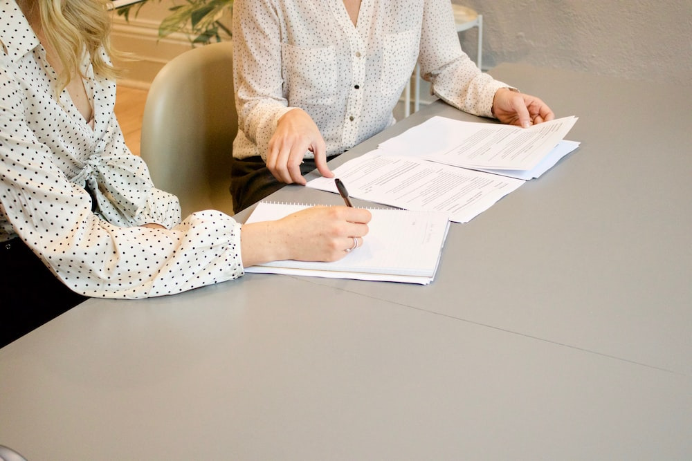 two people working on a document