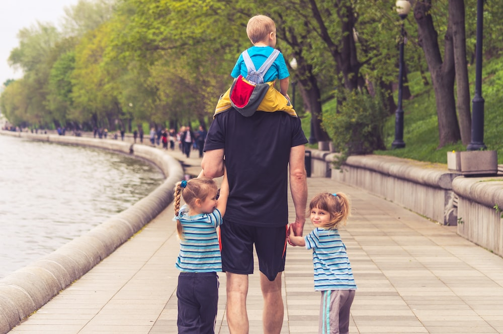 A father taking his kids to a park