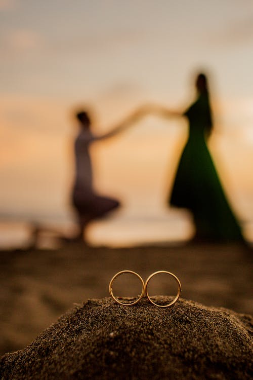 Wedding rings of a couple in the background