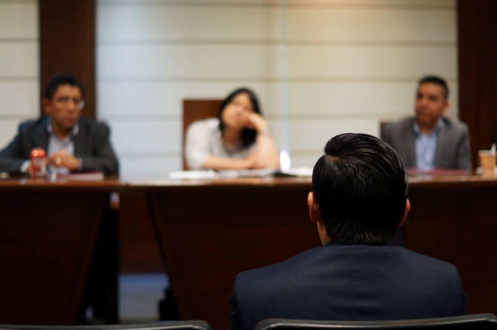 A person sitting in front of a jury