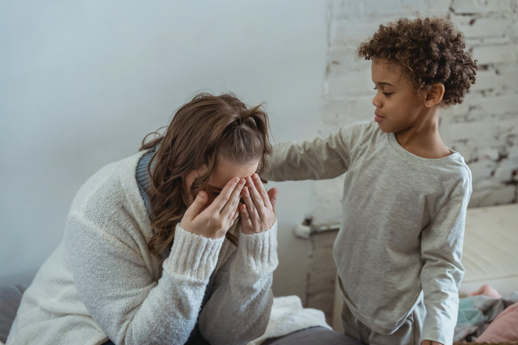 A kid consoling his mother