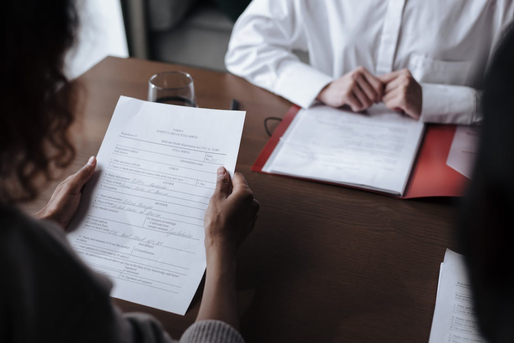 Unrecognizable woman reading legal papers