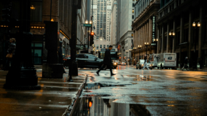 A man crossing a wet road