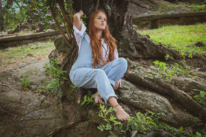 A woman sitting under a tree