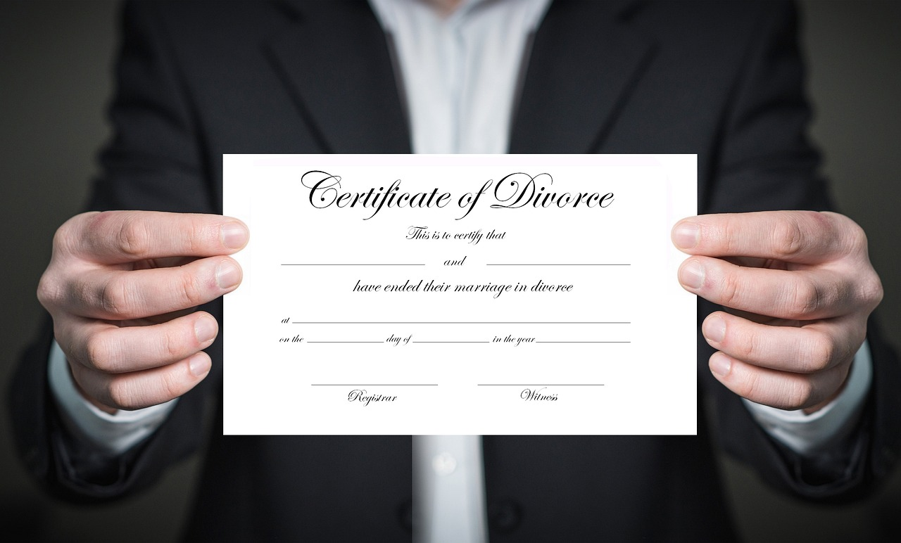 A man holding a certificate of divorce