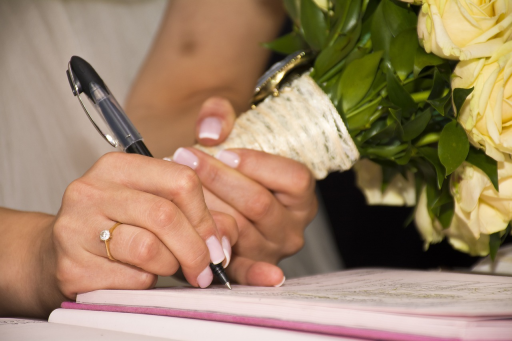 A woman signing a prenuptial agreement