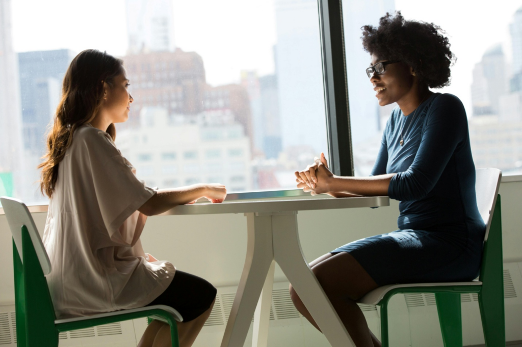 Two people chatting while sitting across a table