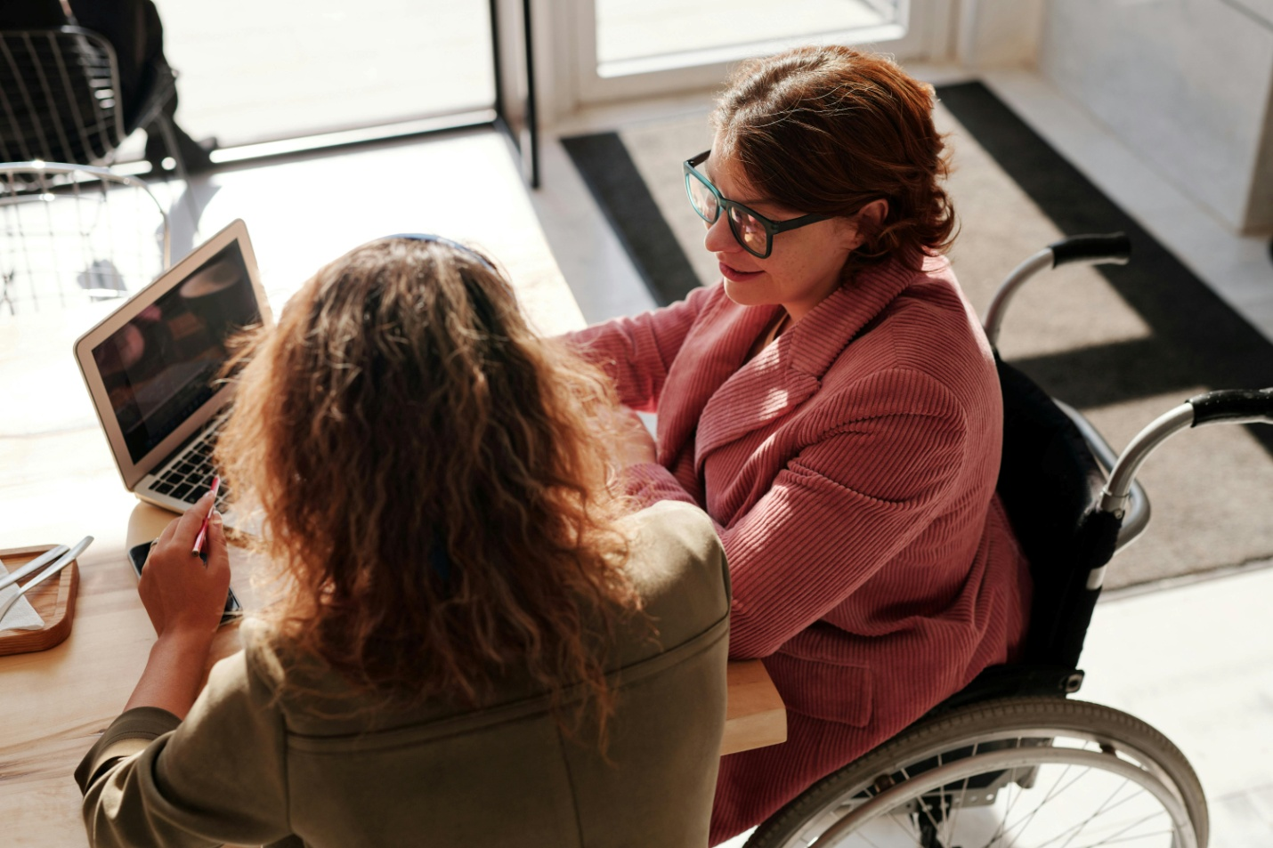A woman in a wheelchair with an injury lawyer in Houston