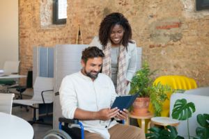 A man in a wheelchair is watching a video on his tablet