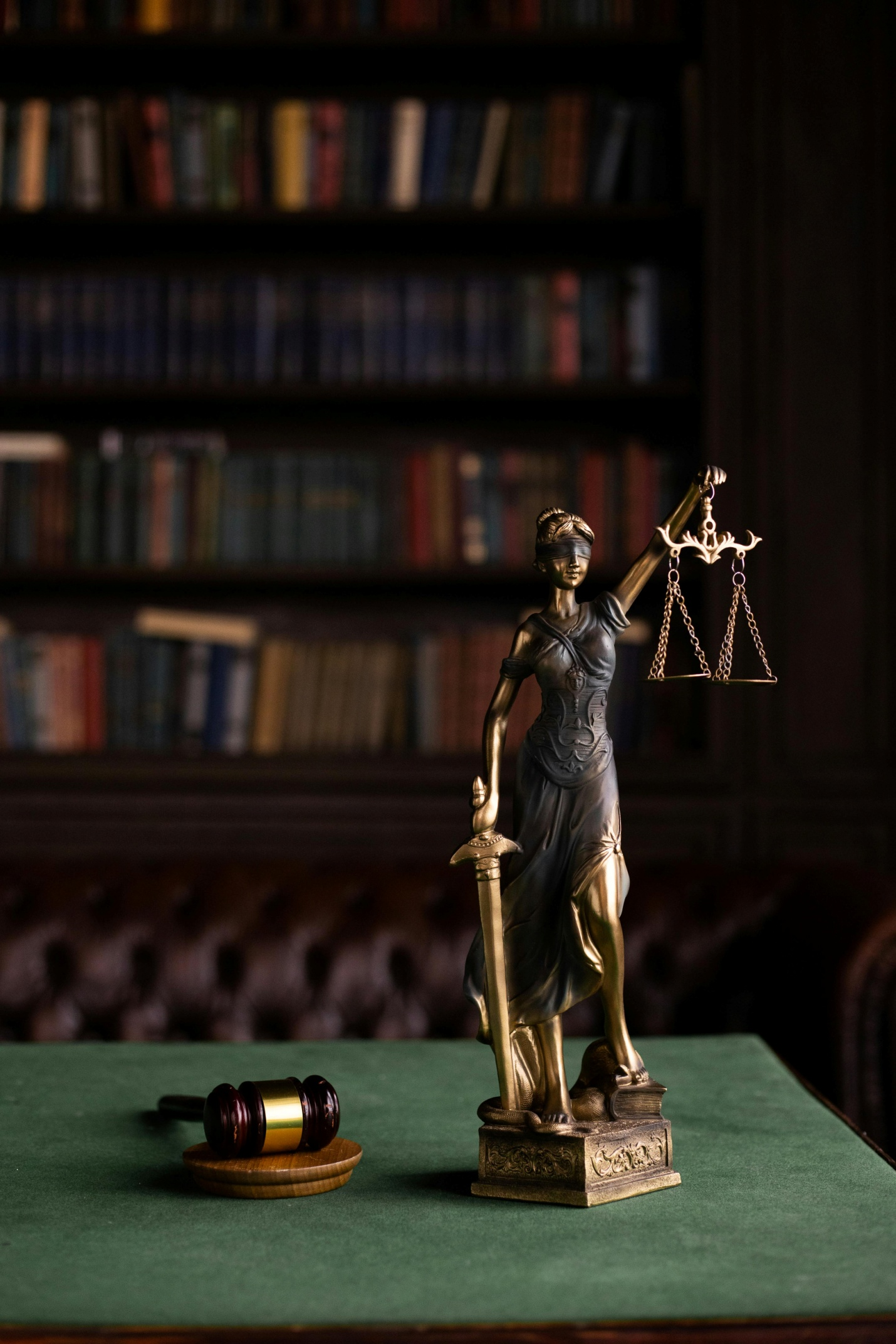 Lady justice and a wooden gavel on a table