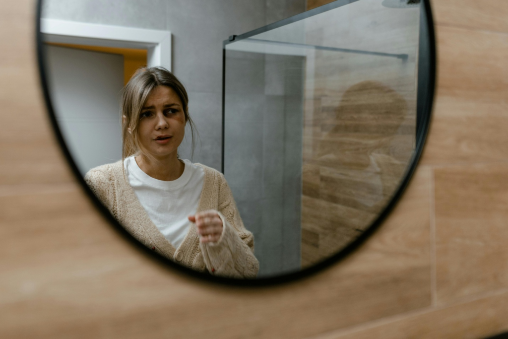 An injured woman looking into a mirror