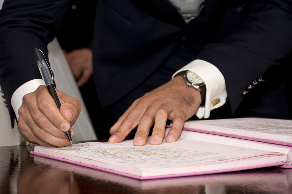 A groom signing a document