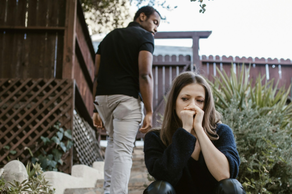 A man walking away from a woman