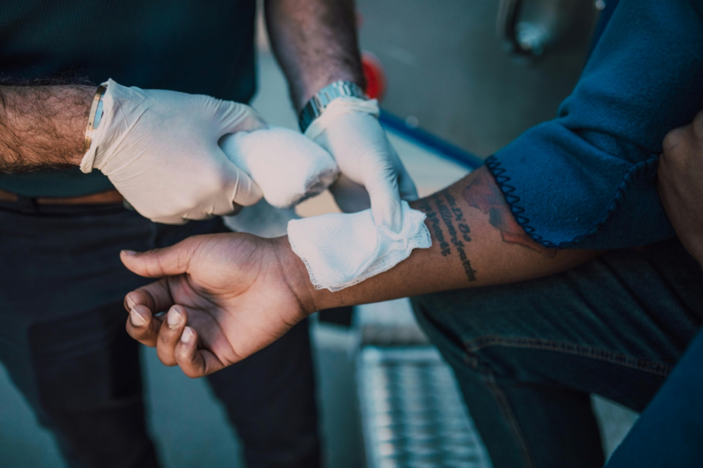 A medical professional attending to an injured person