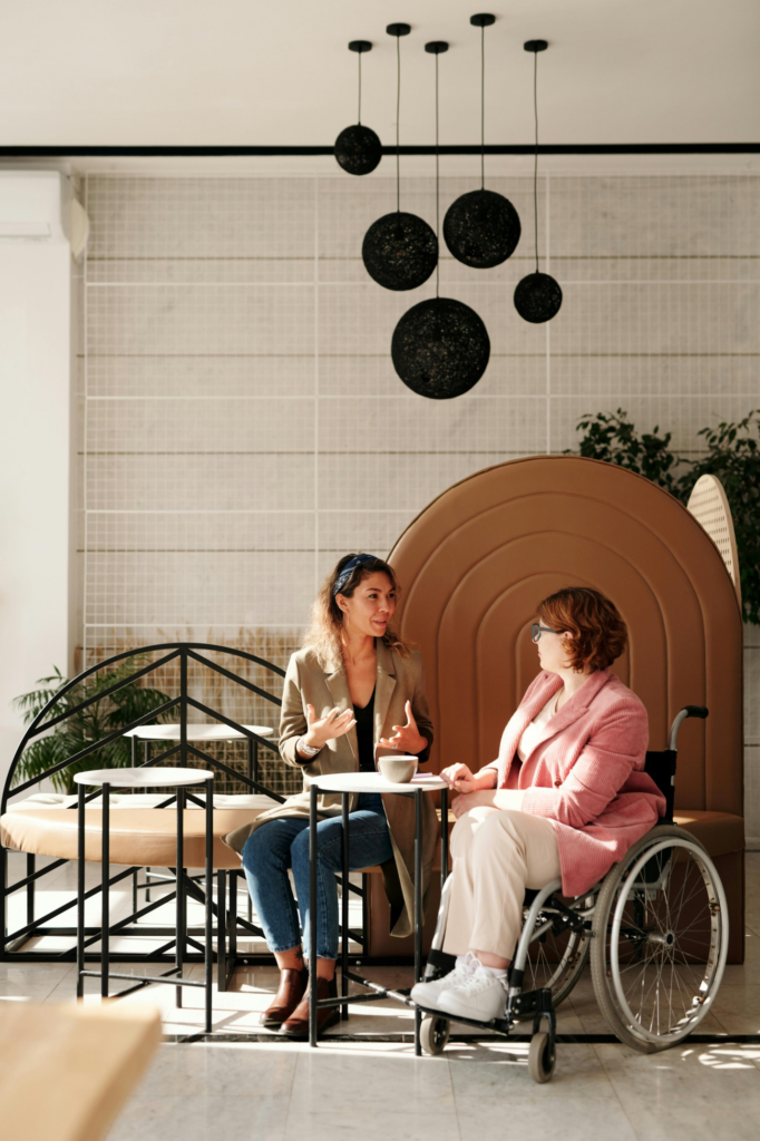 A woman in a wheelchair is talking to a lawyer