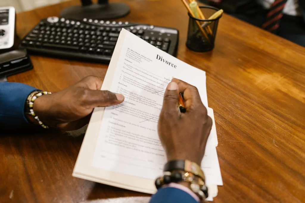 Getting a divorce by https://www.pexels.com/photo/close-up-shot-of-a-person-holding-divorce-papers-7841454/