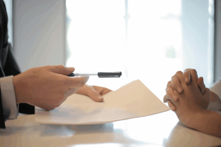 A lawyer handing over a document to a client