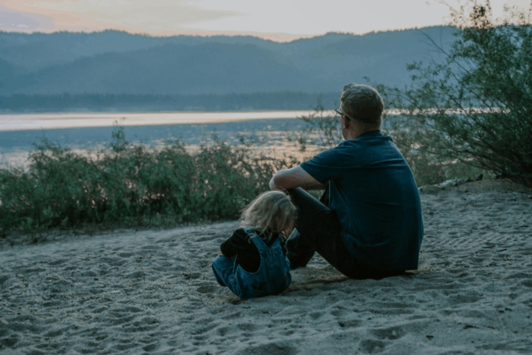 A father enjoying a sunset with his son