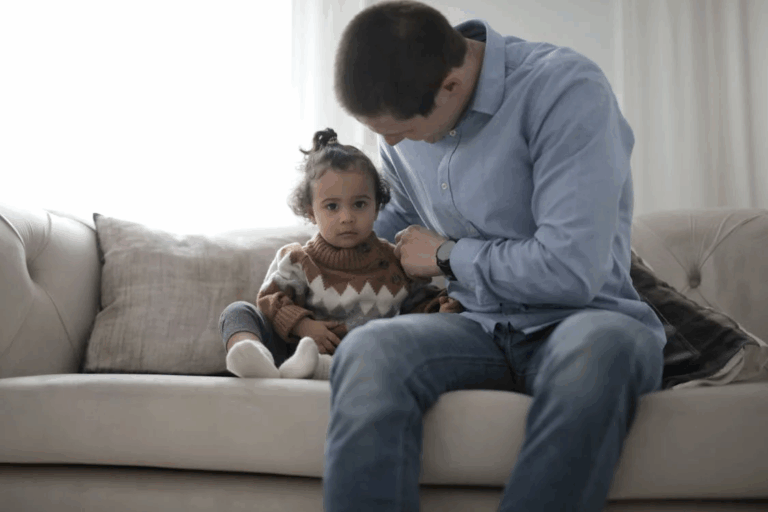 An image of a man sitting beside his child