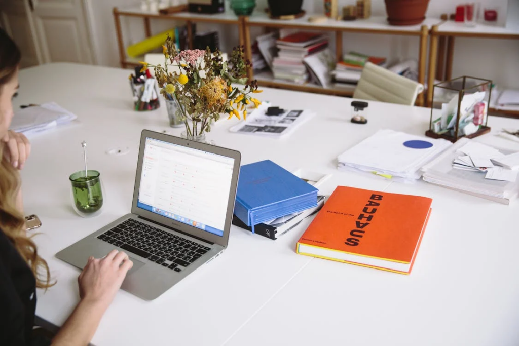 An image of a person working on a laptop