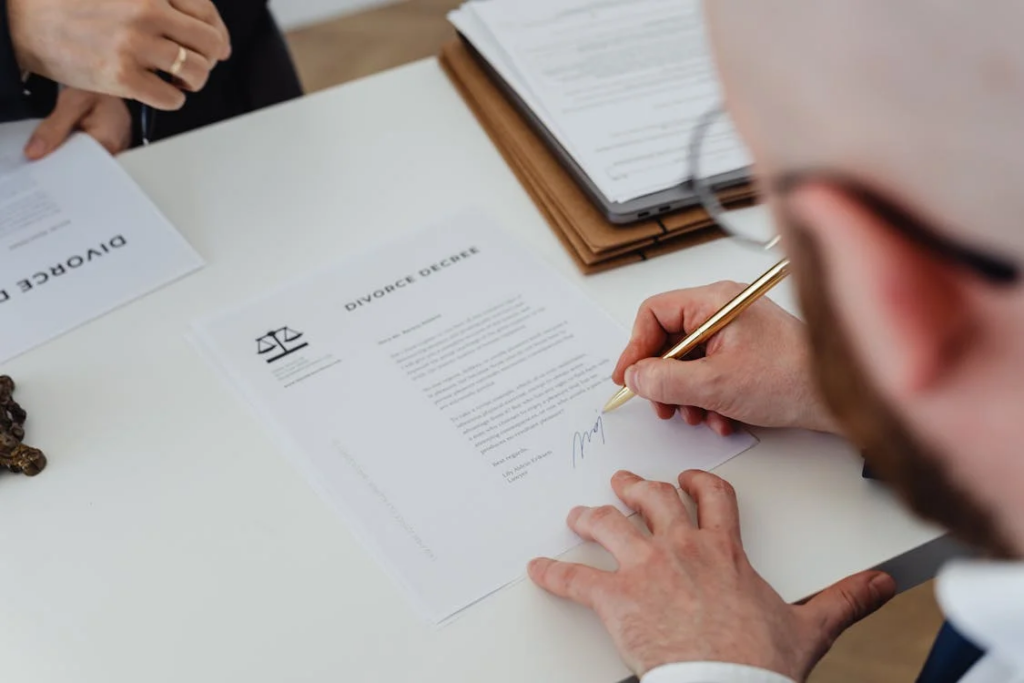 An image of a person signing a divorce document