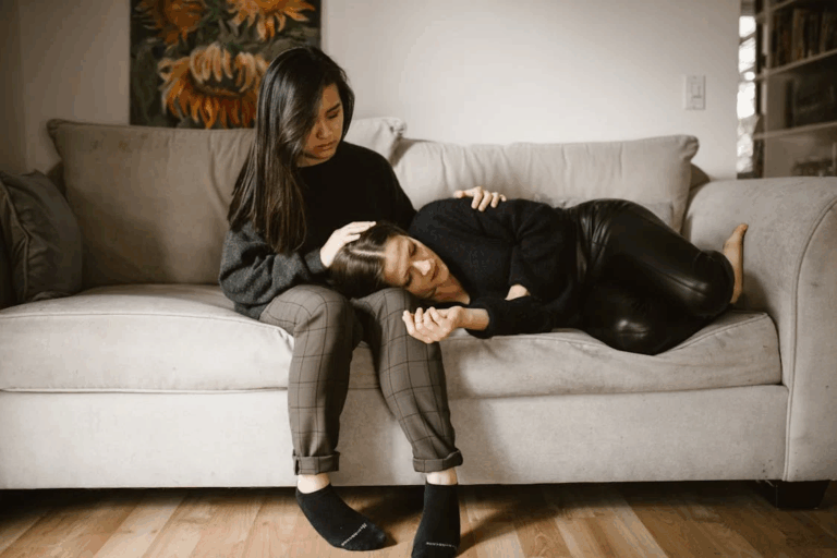 An image of two women sitting on a couch