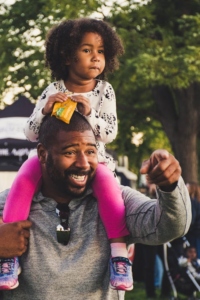 An image of a father holding his daughter     