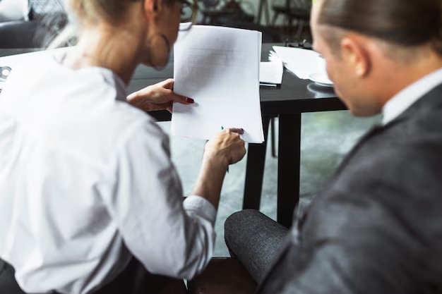 A woman showing a document to a man