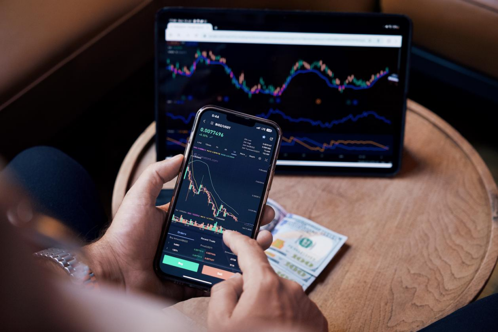 A person looking at a trading graph on his phone
