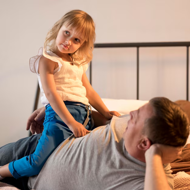 A daughter sitting on her father