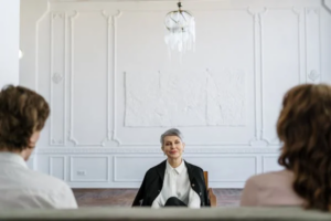 A divorce attorney attentively listening to a couple discussing their common law marriage separation.