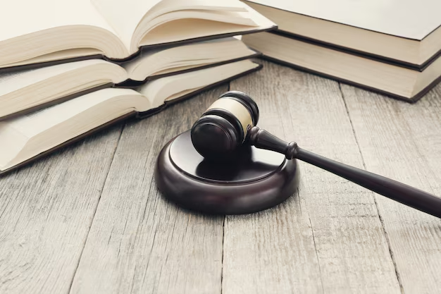 A wooden gavel near books