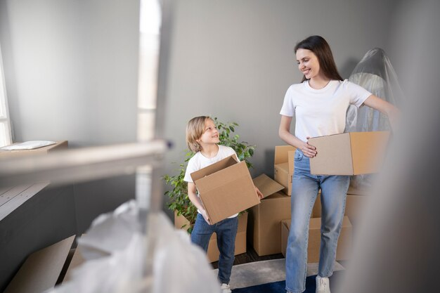 A mother and her son holding boxes