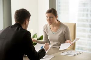 A woman discussing child custody and property division with her lawyer.