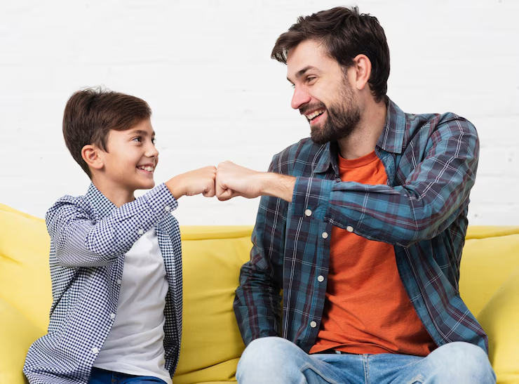 A father and son bumping fists