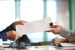 Client submitting legal documents to attorney for a custody modification case.