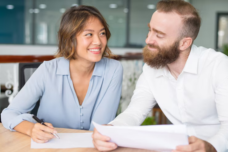 Engaged couple holding prenuptial agreement documents