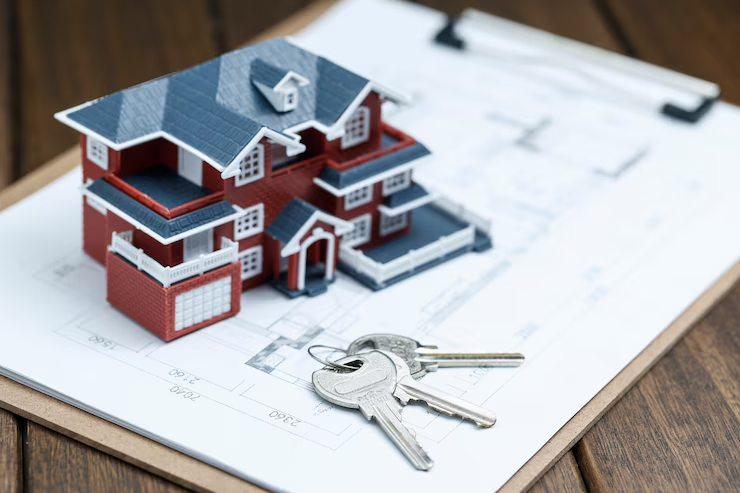 A miniature house placed near a set of keys
