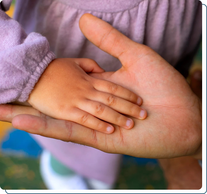 A child holding an adult's hand
