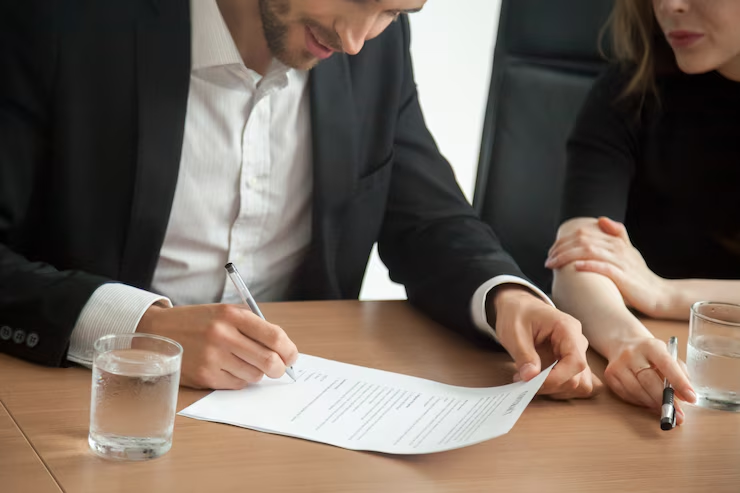 A man signing a contract