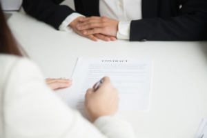 Woman signing her prenuptial agreement with legal counsel in Austin
