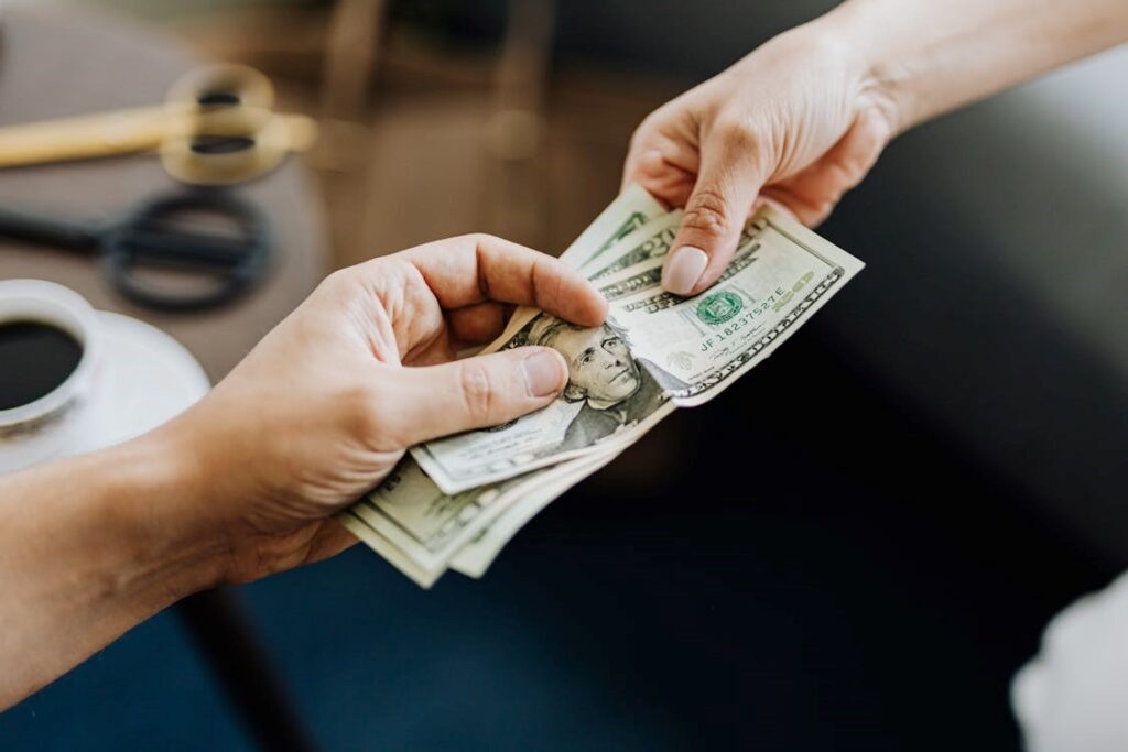 A male and female exchanging money