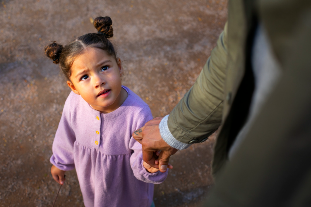 A father holding his little girl’s hand